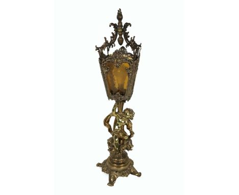 A 19th Century brass Lantern Lamp, with coloured glass and decorative ormolu shade, with cherub support on circular base and 