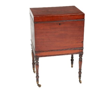 A Georgian period mahogany Tea Caddy, on stand, the lift top opening to reveal metal lined interior with compartments, lion m