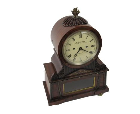A very fine quality Regency period English Bracket Clock, the circular top with brass flame finial and carved motif, the pain