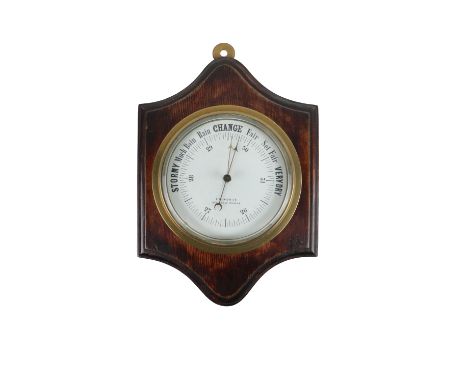 A heavy late 19th Century circular brass Maritime Barometer, with enamel face, signed F.M. Moore, Belfast &amp; Dublin, on a 