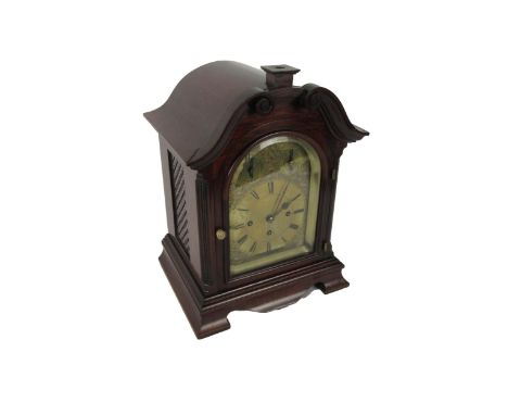 An attractive mahogany cased Mantle Clock, with swan neck pediment over an arched glazed door housing brass dial with Arabic 
