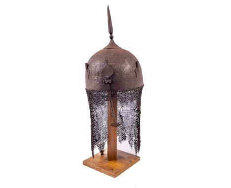 A fine Persian Helmet (Kulah Khud), 19th Century with spike finial on dome head chased with deer hunting scenes, in low relie
