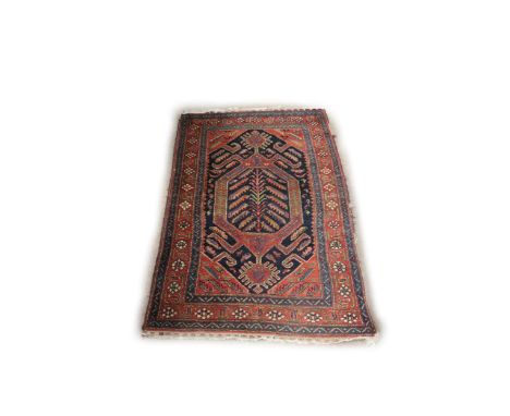An attractive antique woolen oblong Carpet, the central navy ground with floral medallion, the burgundy ground corners with a