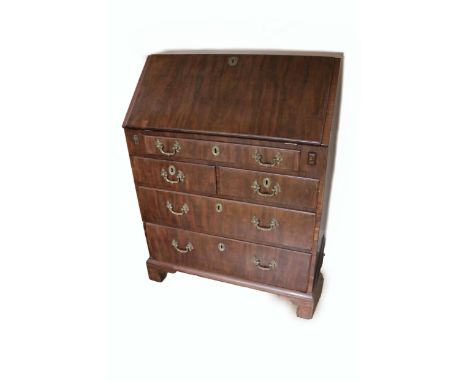 A Georgian period mahogany slope front Bureau, of small proportions, opening to reveal a fitted interior with drawers, pigeon