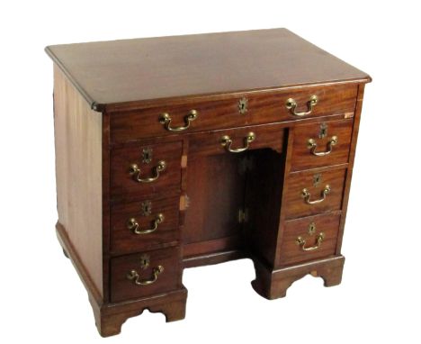 A Georgian period mahogany Gentleman's kneehole Desk, of rectangular shaped moulded top above a long frieze drawer with brass