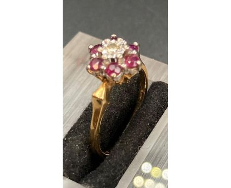 A ruby and diamond ring in a daisy style with central diamond surrounded by six rubies (Approximate Total Weight 3.5g) size M