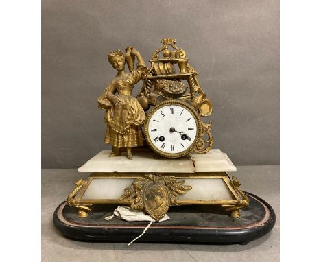 A French eight day gilt clock with enamel face on a marble base 