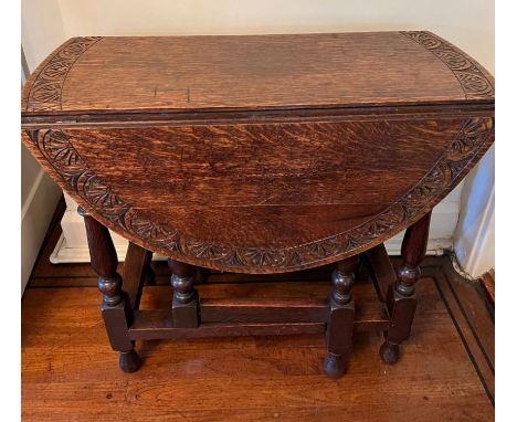 A small gate leg breakfast table with carved rim (H75cm W83cm D41cm)