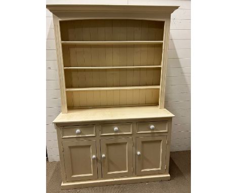 A painted pine dresser with white ceramic knob handles, three shelf plate rack over three drawers and three cupboards (H204cm