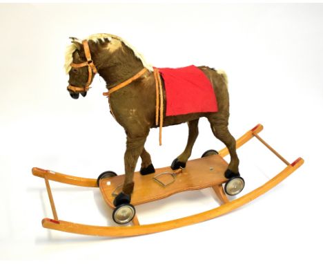 A plush model horse with tack on rocker base, approx 85 x 122cm (af).Additional InformationThe stirrups have become detached 