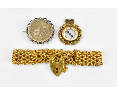 A yellow metal chain link bracelet with heart shaped lock clasp, approx 29.8g, also a gold plated compass fob, and a mounted 