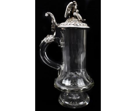 A circa 1900 Continental white metal mounted clear glass jug, possibly Austro-Hungarian, the hinged lid with eagle finial, wi