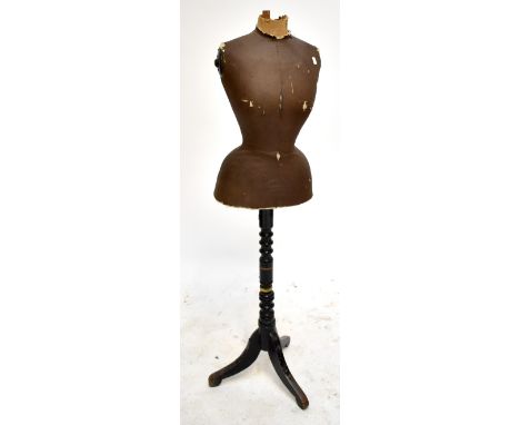 A tailor's mannequin on ebonised tripod stand, height 145cm.Additional InformationPartially legible stamp stating 'Harris &am