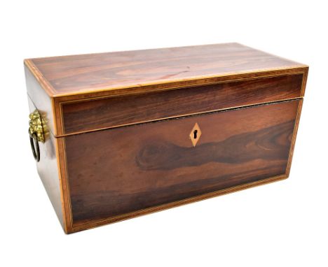 A Regency rosewood, cross banded inlaid rectangular tea caddy with twin lion mask and loop handles, the three section interio