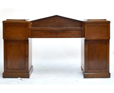 A 19th century burr walnut drop centre twin pedestal sideboard of architectural form with central drawer flanked by cupboards