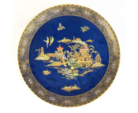 WILTSHAW &amp; ROBINSON, CARLTON WARE; a large chinoiserie decorated blue ground charger, printed marks to the reverse, diame