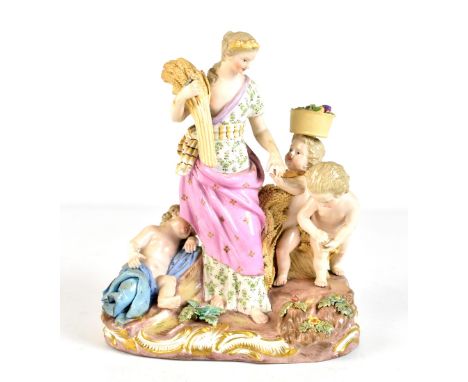 MEISSEN; a late 19th century figure group representing autumn/harvest, with central figure surrounded by three putti, blue pa