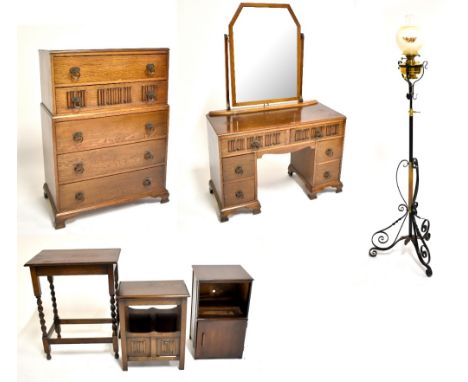 A group of furniture comprising an oak chest of five drawers on bracket feet, 117 x 82cm, a matching mirror back dressing tab