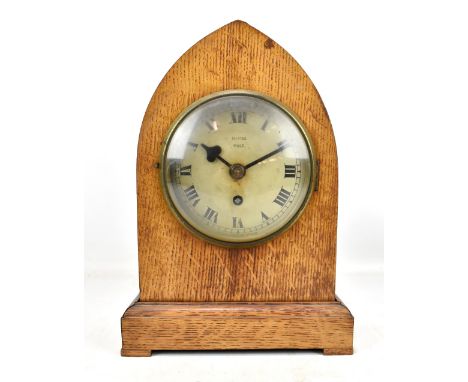 DAVIES OF HALE; an early 20th century lancet shaped mantel clock, the silvered circular dial set with Arabic numerals and sig