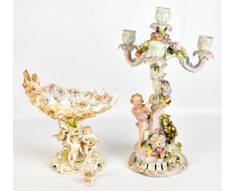 VOLKDSTADT; a porcelain shell moulded cherubic decorated pedestal bowl, height 24cm, and a Continental figural candelabrum, h