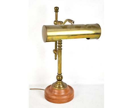 A modern brass adjustable desk lamp, raised on wooden base, height 58cm.