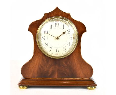 An Edwardian mahogany and inlaid mantel clock, the circular dial set with Arabic numerals, the movement back plate stamped wi