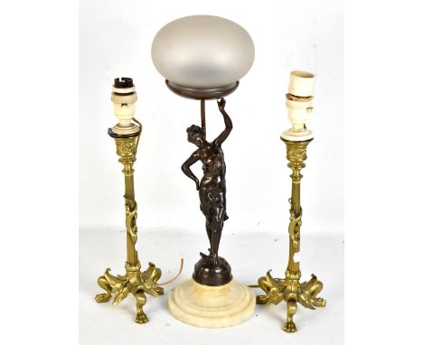 An early 20th century bronzed spelter figural table lamp modelled in the form of a semi-nude female supporting a frosted glas