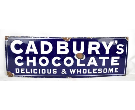 An original enamel advertising sign inscribed 'Cadbury's Chocolate, Delicious &amp; Wholesome', 30 x 91cm.