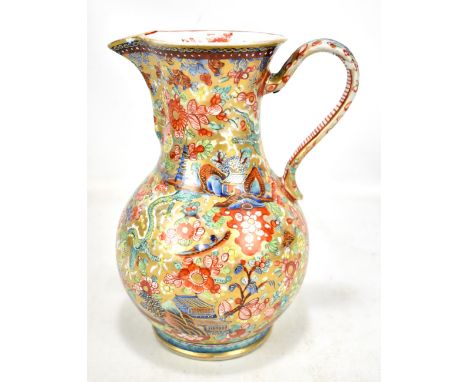 A late 18th/early 19th century Chinese clobbered sparrow beak ewer decorated with a typical landscape amongst flora and fauna