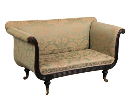 A REGENCY MAHOGANY SOFA covered in green damask, with straight back and high scrolling arms terminating with flowerhead round