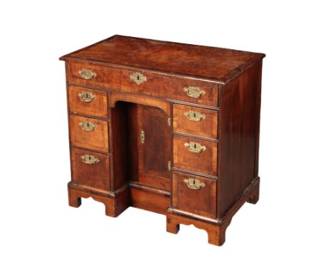 A GEORGE II BURR WALNUT AND MAHOGANY KNEEHOLE DESK18th century and later, the rectangular moulded top over shallow frieze dra