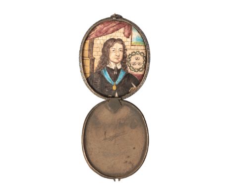 ENGLISH SCHOOL, 17TH CENTURY A portrait miniature on enamel, depicting a gentleman in an interior, an armorial to the backgro