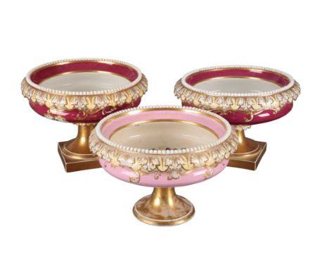 A GROUP OF THREE H & R DANIEL SHELL SHAPE CENTREPIECES including one in pattern 4541, with pink borders, 19.5cm high, one dec