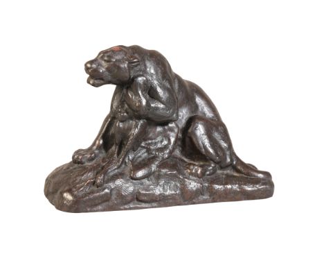 A PATINATED BRONZE OF A LIONESS 19th century, snarling whilst clutching its lifeless prey in one paw, 9cm high