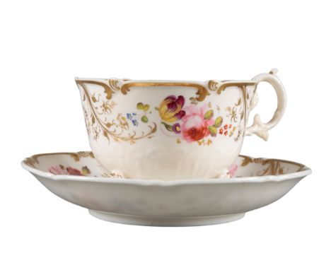 AN H & R DANIEL C-SCROLL CUP AND SAUCER pattern 4365, the white ground decorated with floral sprays and gilt foliage, the cup