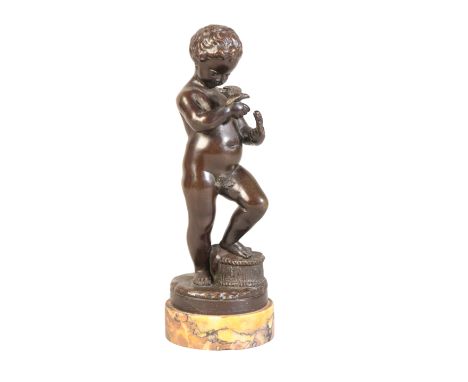AFTER CLAUDE MICHEL CLODION (1738-1814), A PATINATED BRONZE CHERUB19th century, tenderly feeding a bird perched on his hand w