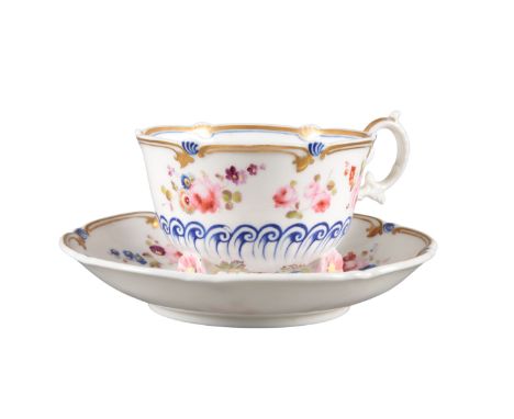 AN H & R DANIEL C-SCROLL CUP AND SAUCER pattern number 4377, with white ground decorated with a border of roses and blue enam