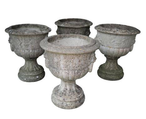 A SET OF FOUR RECONSTITUTED STONE NEO-CLASSICAL URNS20th century, with stone cast lion mask ring handles and griffon panels, 