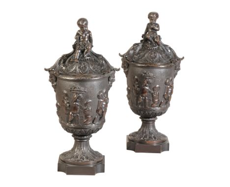 A MATCHED PAIR OF LARGE PATINATED BRONZE URNS WITH COVERSlate 19th century, the identical urn bodies decorated with harvestin