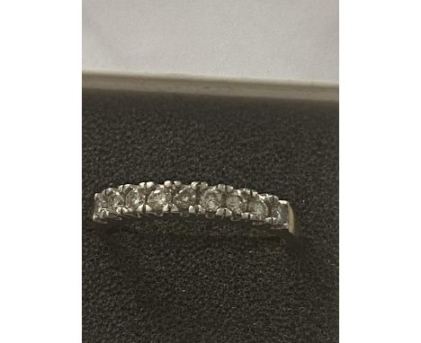 AN 18 CARAT GOLD RING SET WITH 9 IN LINE DIAMONDS - 0.33 CARAT - RING SIZE N 