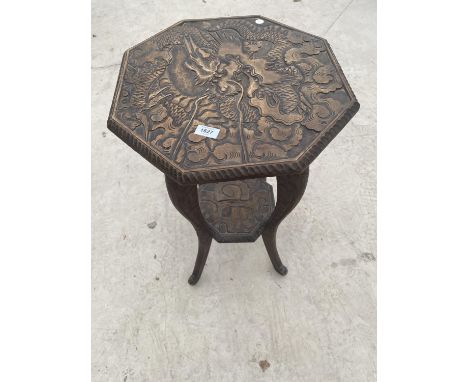 AN OCTAGONAL MAHOGANY SIDE TABLE WITH HEAVILY CARVED TOP, LOWER SHELF AND SUPPORTS 