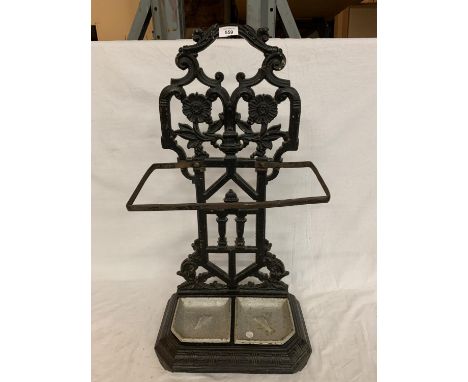 A CAST METAL STICK/UMBRELLA STAND WITH BOTH TRAYS 