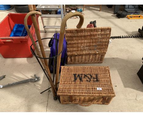 A WICKER BASKET AND A STICK STAND WITH THREE STICKS 