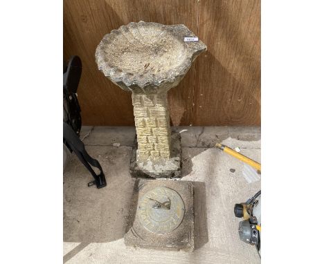 A SUNDIAL ON A CONCRETE BASE AND A CONCRETE BIRD BATH 
