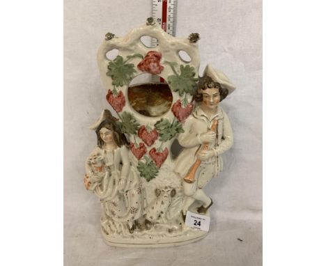 A STAFFORDSHIRE CERAMIC FIGURE OF A LADY AND GENT WITH SPANIEL POCKET WATCH STAND 