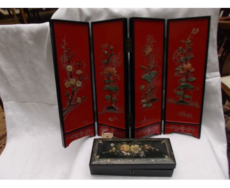 A small black painted 4 fold rectangular oriental screen and a smaller rectangular playing card box incl. early Happy Family 