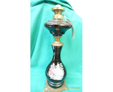 Oil lamp (no shade or flue) the black porcelain centre decorated courting couple all on splayed brass base