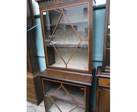 Mahogany display cupboard, the upper portion with diamond shaped glazed panel with 2 shelves behind, ornamental frieze to top