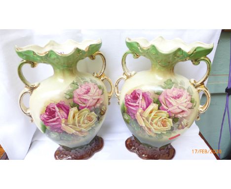 Pair of handled urn shaped mantelpiece vases decorated coloured pink and yellow roses