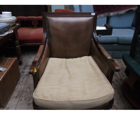 Oak framed fireside chair on tapering fluted legs, the studded back, arms and part seat upholstered in light brown leather